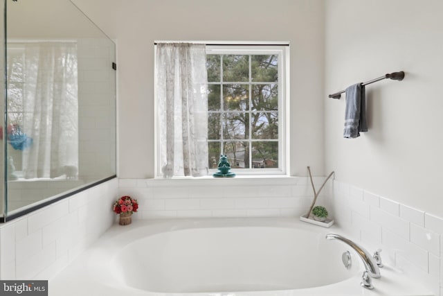 bathroom with a garden tub