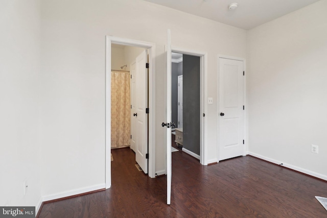 unfurnished bedroom with baseboards and wood finished floors