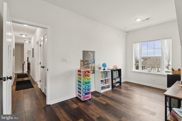 playroom featuring visible vents, dark wood finished floors, and baseboards