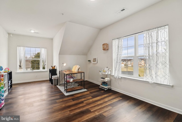 interior space featuring baseboards, visible vents, vaulted ceiling, and dark wood-style flooring