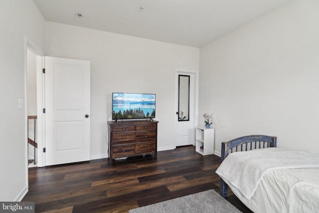 bedroom with baseboards and wood finished floors