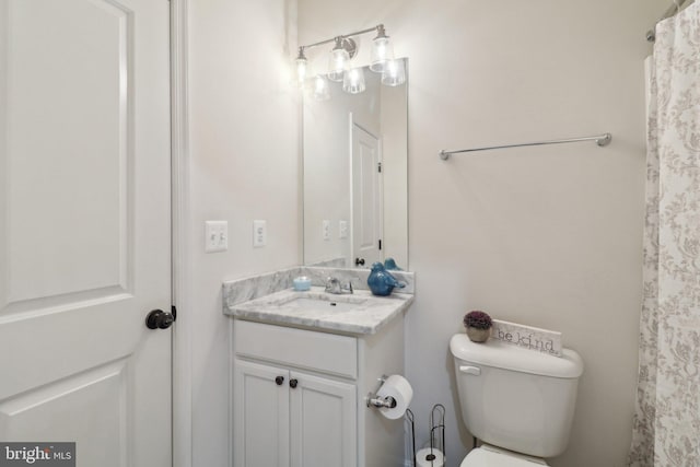 bathroom featuring toilet and vanity