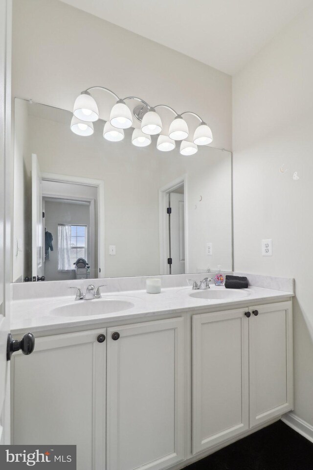 bathroom featuring a sink and double vanity