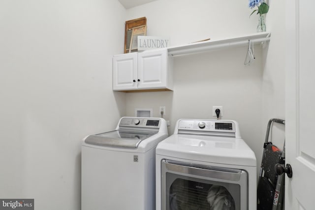 laundry room featuring cabinet space and washing machine and clothes dryer