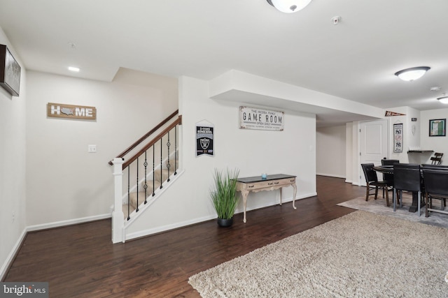 interior space with stairs, baseboards, and wood finished floors