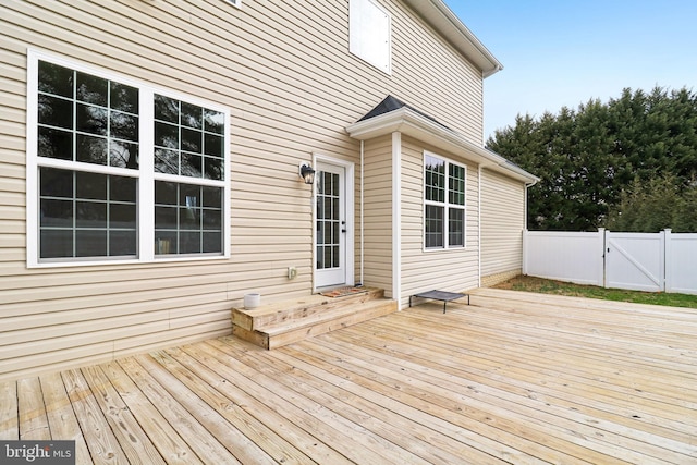 wooden deck with a gate and fence