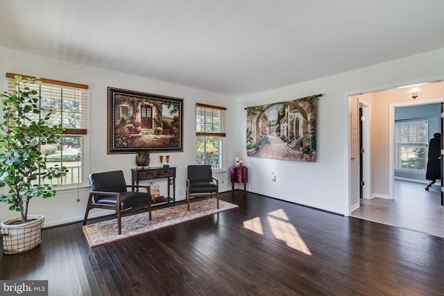 living area featuring ornamental molding, plenty of natural light, baseboards, and wood finished floors