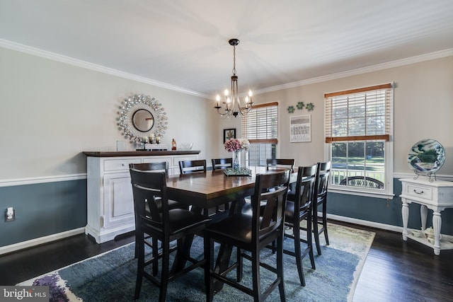 dining room with ornamental molding, dark wood-type flooring, baseboards, and an inviting chandelier