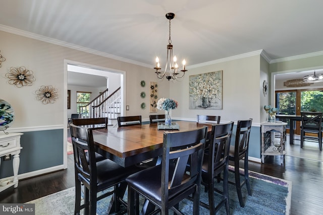 dining space with plenty of natural light, crown molding, and wood finished floors