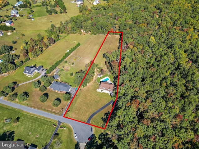 birds eye view of property with a rural view