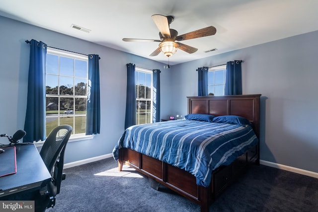 bedroom featuring carpet floors, multiple windows, visible vents, and baseboards