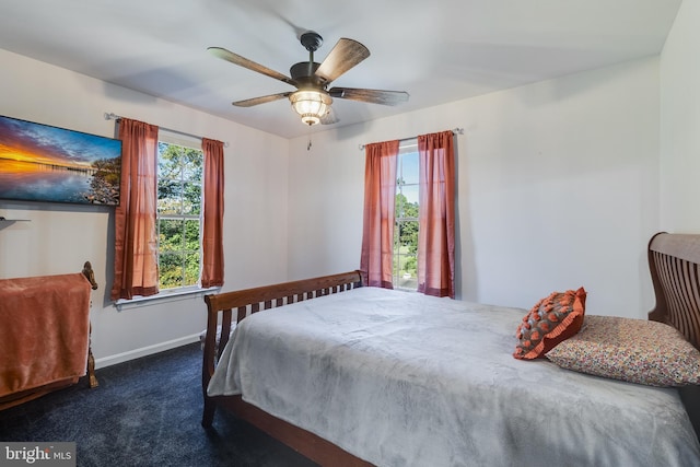 bedroom with carpet floors, a ceiling fan, and baseboards