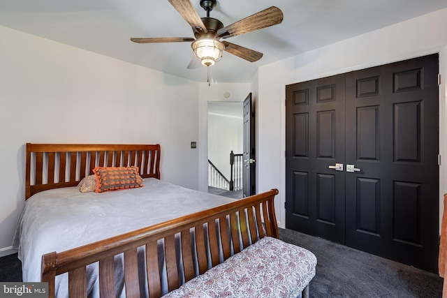 bedroom featuring a ceiling fan, a closet, and dark carpet