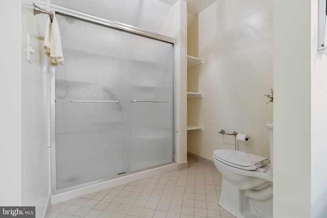 bathroom featuring a stall shower, baseboards, toilet, and tile patterned floors