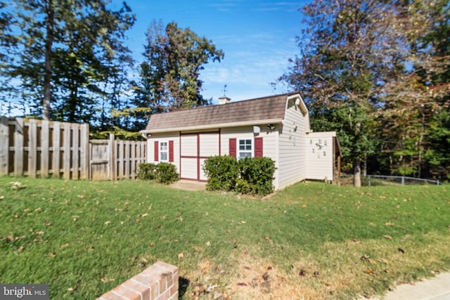 exterior space with fence and an outbuilding