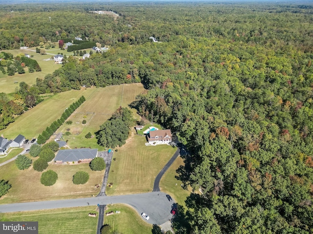 birds eye view of property with a wooded view