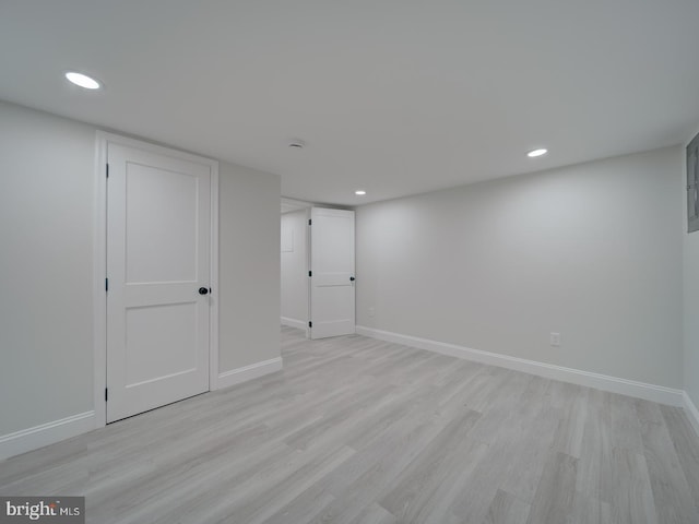 finished below grade area featuring light wood-style floors, baseboards, and recessed lighting