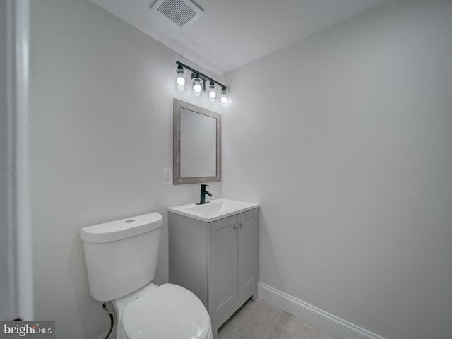 half bathroom with baseboards, visible vents, toilet, tile patterned floors, and vanity