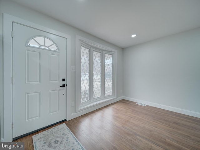 foyer entrance with recessed lighting, visible vents, baseboards, and wood finished floors