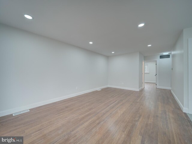 below grade area with recessed lighting, wood finished floors, visible vents, and baseboards