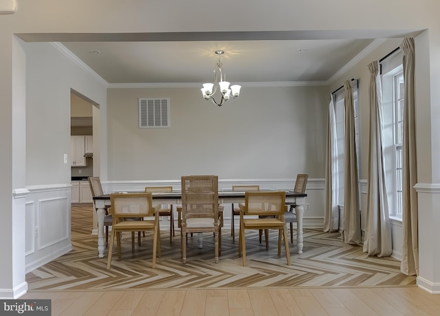 dining area with ornamental molding, parquet floors, visible vents, and a chandelier