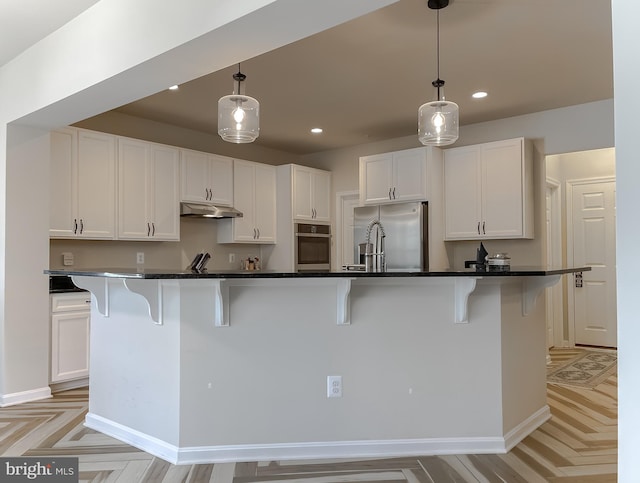 kitchen with white cabinetry, recessed lighting, under cabinet range hood, and stainless steel appliances