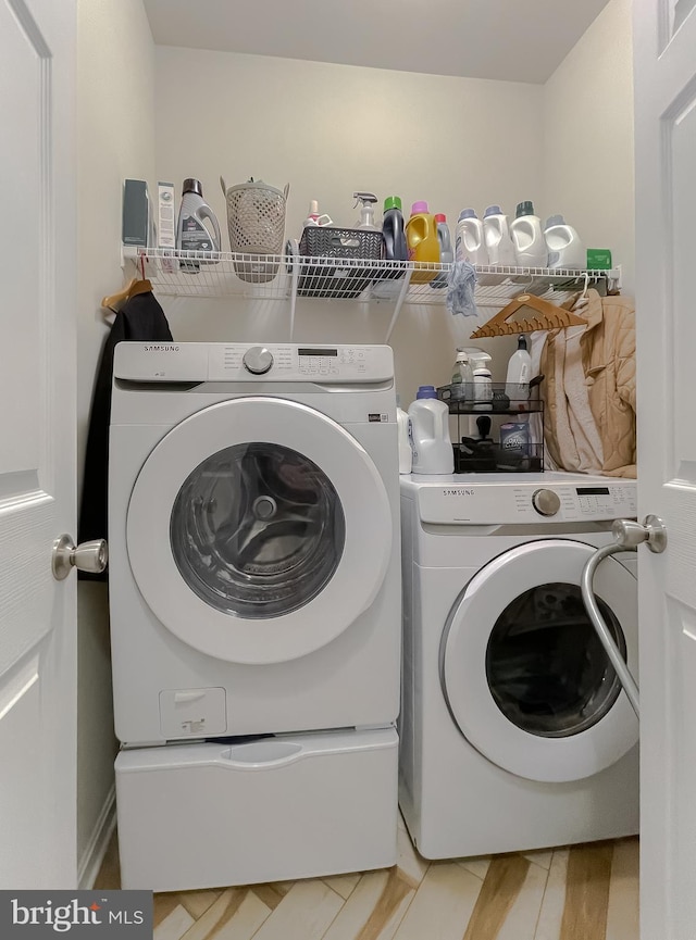 laundry room featuring washing machine and clothes dryer and laundry area