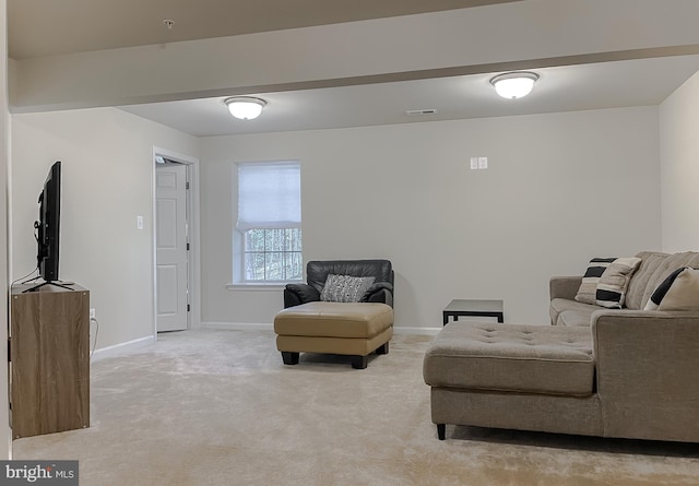 living area with visible vents, light colored carpet, and baseboards