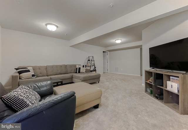 living area with visible vents, light colored carpet, and baseboards