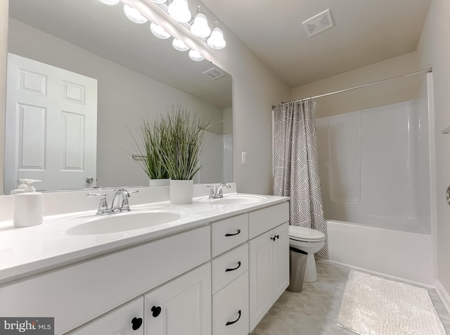 bathroom with double vanity, visible vents, toilet, and a sink