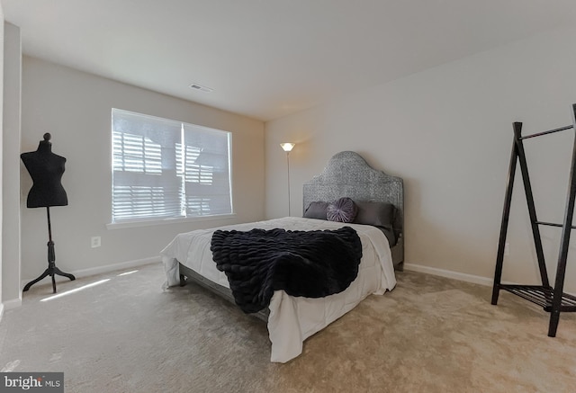 carpeted bedroom featuring visible vents and baseboards