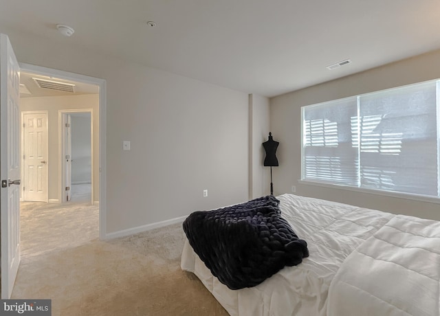 bedroom featuring light colored carpet, visible vents, and baseboards