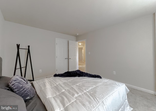 bedroom featuring baseboards and light carpet