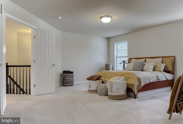 carpeted bedroom featuring baseboards