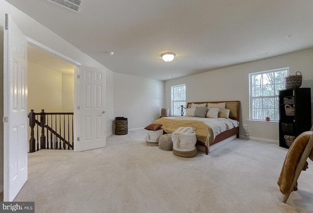 carpeted bedroom featuring baseboards and visible vents