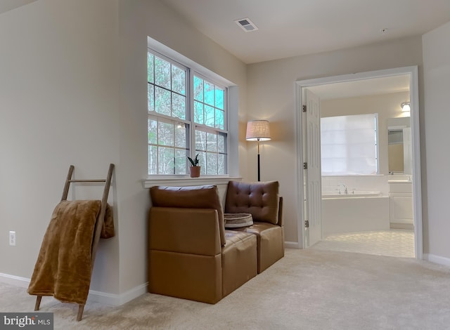 living area featuring carpet, visible vents, and baseboards