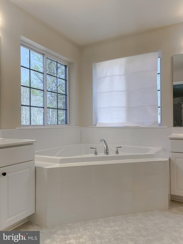 full bathroom with vanity and a garden tub