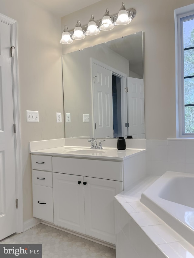 bathroom featuring vanity and a bath