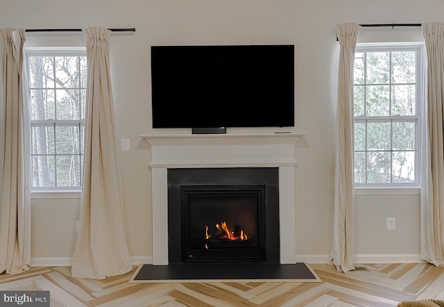 room details with a fireplace with flush hearth and baseboards