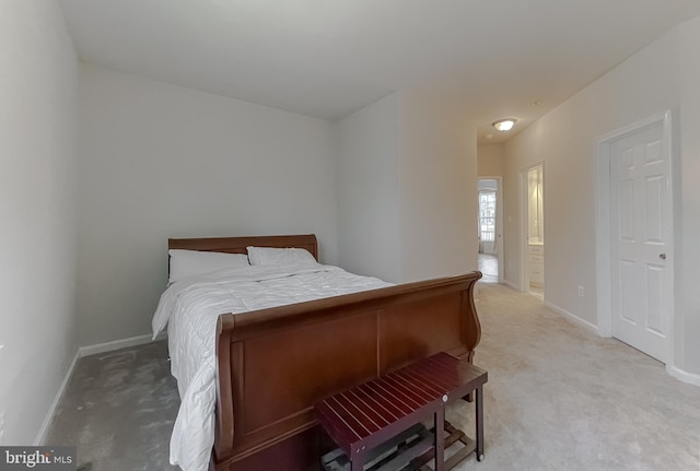 bedroom with baseboards and light carpet