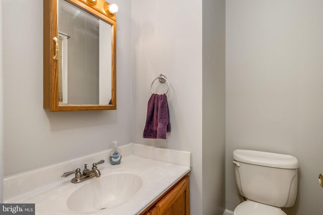 half bathroom featuring toilet and vanity