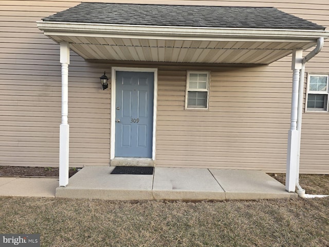 entrance to property with roof with shingles