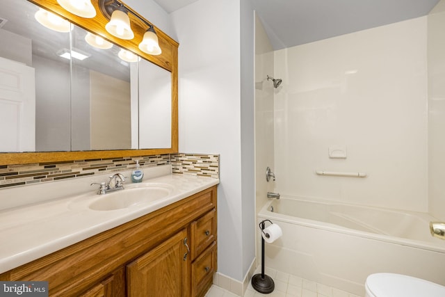 full bath featuring vanity, tile patterned flooring, shower / washtub combination, toilet, and backsplash