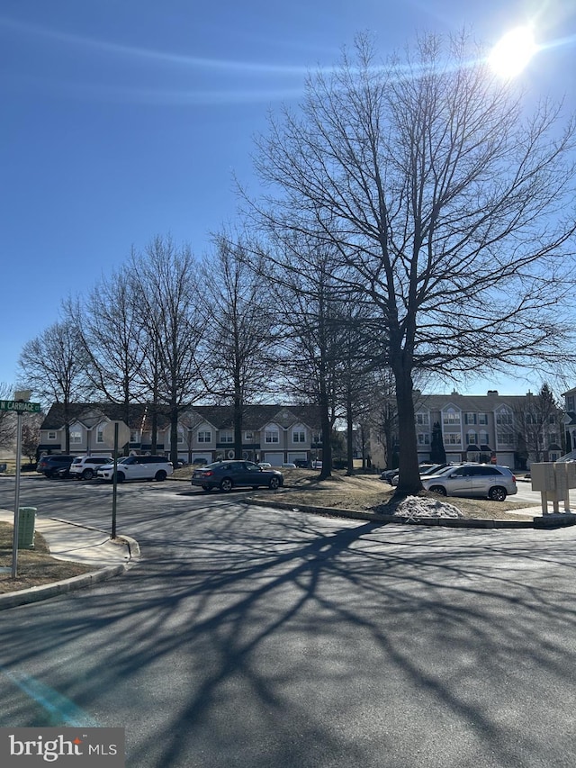 view of street featuring a residential view, curbs, and sidewalks