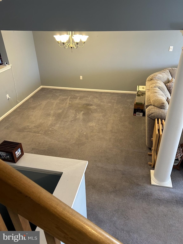 interior space with a chandelier, carpet flooring, and baseboards