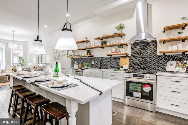 kitchen with wall chimney exhaust hood, stainless steel electric range, open shelves, and white cabinetry