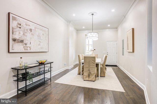 dining room with ornamental molding, dark wood finished floors, and baseboards