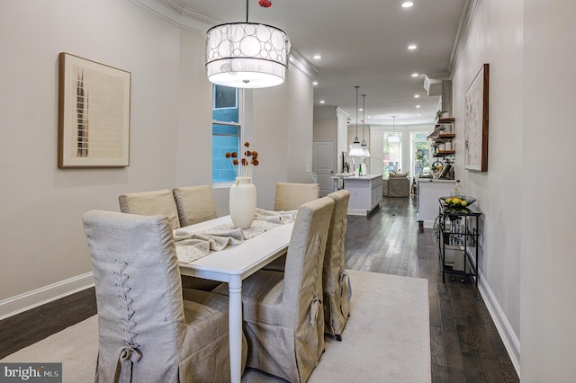 dining area featuring dark wood-style floors, ornamental molding, baseboards, and recessed lighting