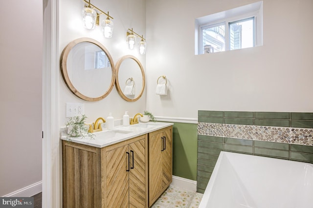 full bath featuring tile patterned flooring, a soaking tub, a sink, and double vanity