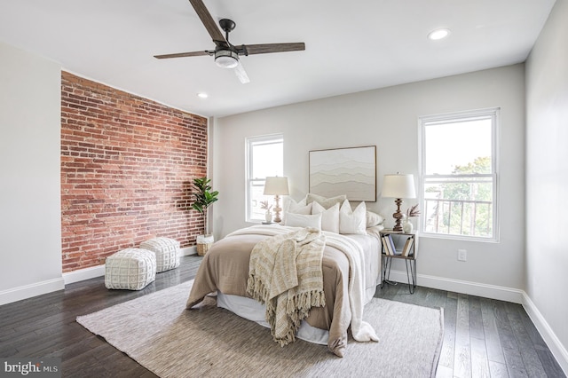 bedroom with ceiling fan, recessed lighting, brick wall, baseboards, and wood-type flooring